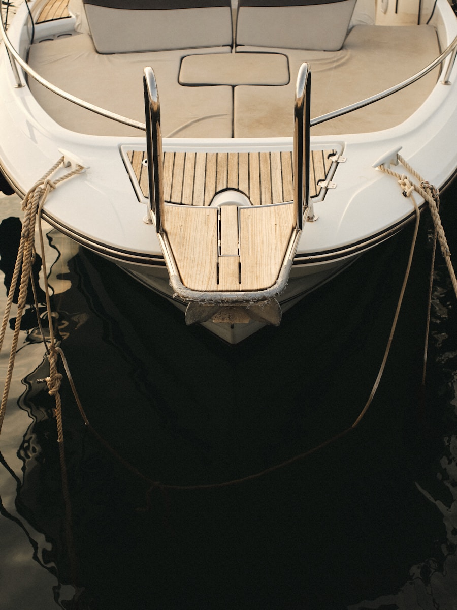 A white boat is docked in the water