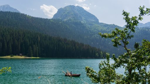 a couple of boats floating on top of a lake