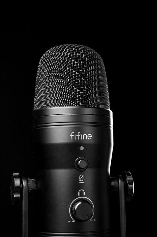 A black microphone with a black background