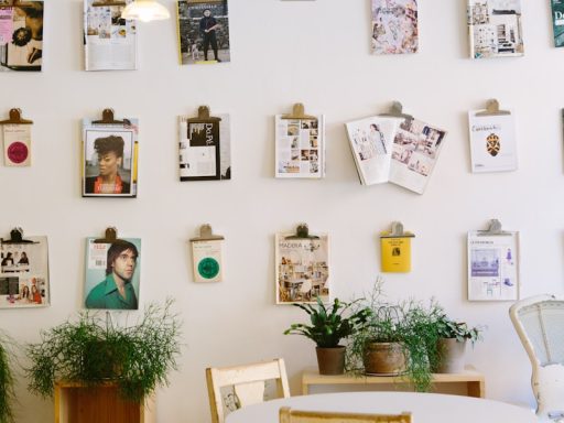 magazines hanged on wall near round beige wooden table