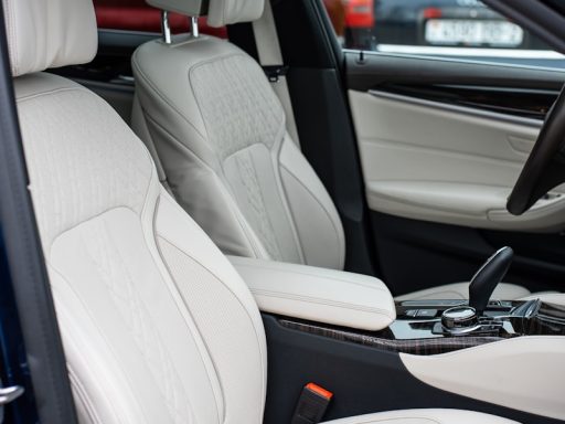 the interior of a car with white leather seats