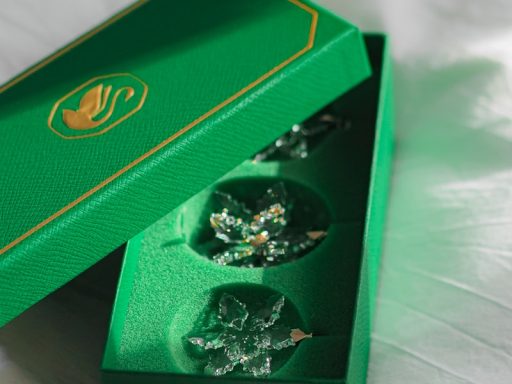 A green box with two pieces of cake inside of it