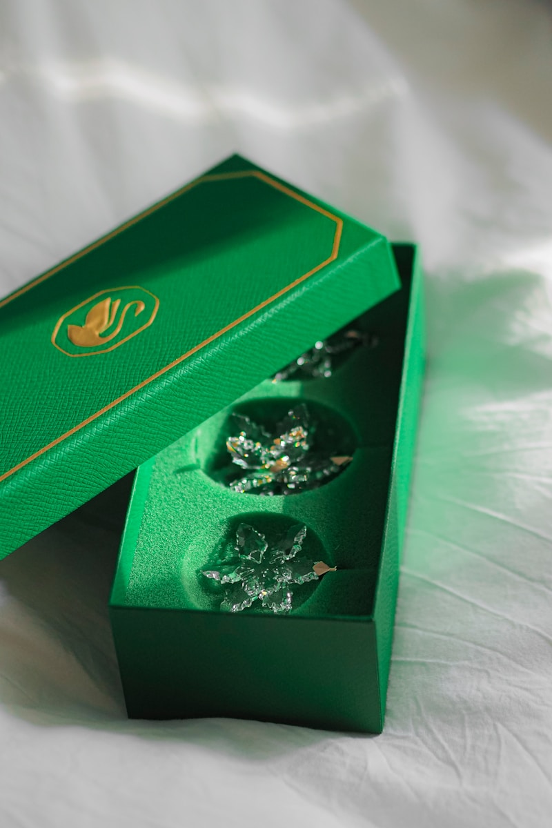 A green box with two pieces of cake inside of it
