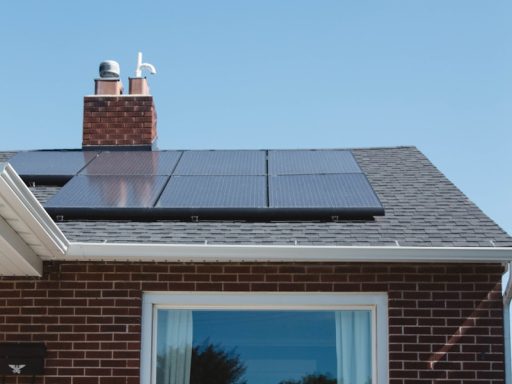 brown brick house with solar panels on roof