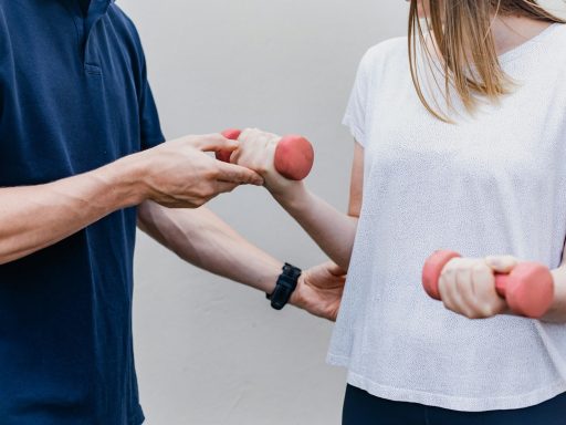 a man and a woman holding dumbs in their hands