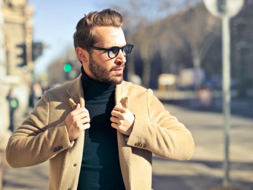 selective focus photography of man wear brown blazer and eyeglasses