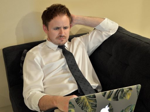 Man die op een laptop werkt vanuit huis om online bij te verdienen