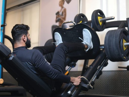 man in black long sleeve shirt sitting on black exercise equipment